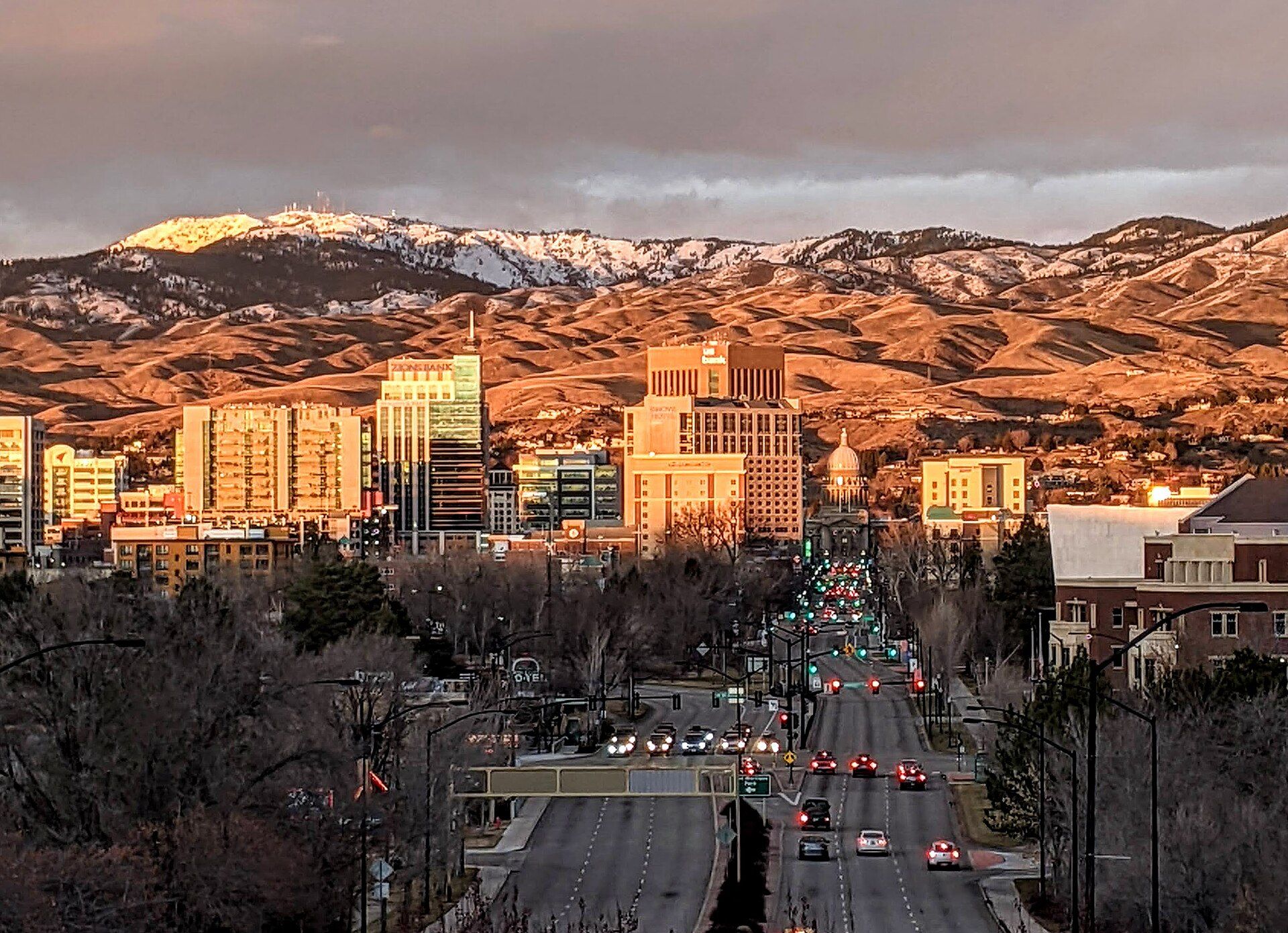 Downtown Boise with the Idaho State Capitol dome, and snow on the foothills behind it